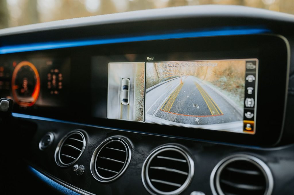 Close-up of a car dashboard showcasing a rear-view camera display and modern electronics. — examplearticle